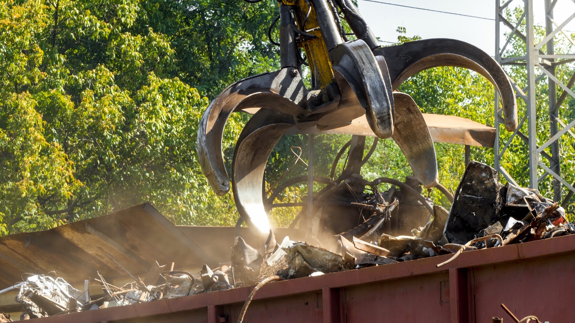 Special claw gripper working on metal scrapyard with old rusty pieces